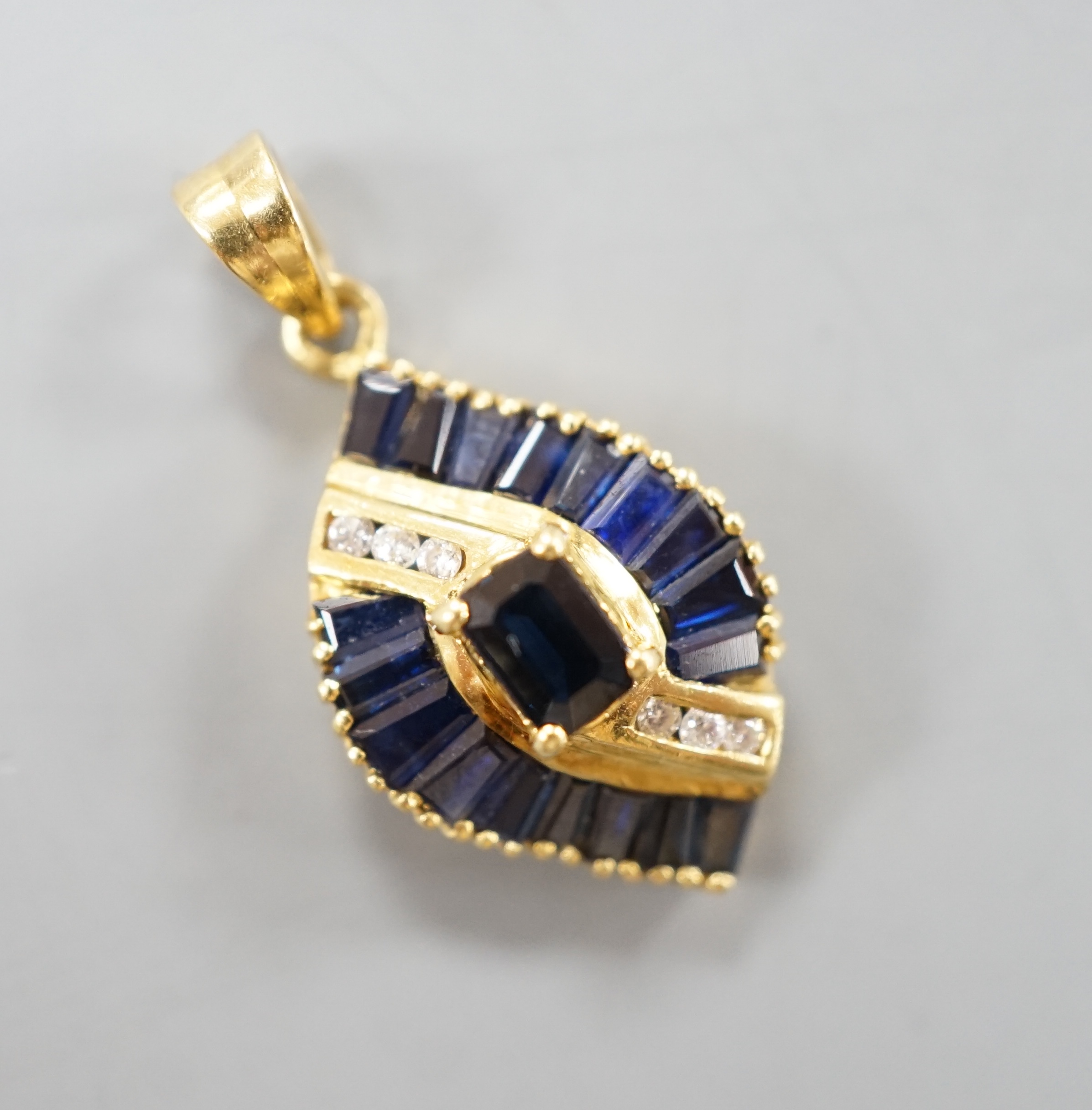 A modern gold, sapphire and diamond cluster set oval pendant, 19mm, gross 3.9 grams.